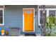 Inviting home featuring a vibrant orange front door and charming architectural details at 5005 Tangerine S Ave, Gulfport, FL 33707