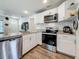 Modern kitchen with stainless steel appliances, white cabinets, and granite countertops at 5005 Tangerine S Ave, Gulfport, FL 33707
