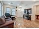 Cozy living room featuring hardwood floors, a comfortable sofa, and a television with piano below at 5005 Tangerine S Ave, Gulfport, FL 33707