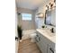 Bathroom features a shower and tub, a large vanity with modern fixtures, and wood-look floors at 5151 7Th N Ave, St Petersburg, FL 33710