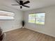 Bright bedroom with ceiling fan, two windows, and new flooring at 5151 7Th N Ave, St Petersburg, FL 33710