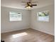 Cozy bedroom featuring a ceiling fan, two windows, and light colored flooring at 5151 7Th N Ave, St Petersburg, FL 33710