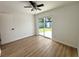 Bedroom with new flooring, neutral paint, and sliding glass door with backyard access at 5151 7Th N Ave, St Petersburg, FL 33710