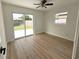 Bedroom with new flooring, neutral paint, and sliding glass door and yard view at 5151 7Th N Ave, St Petersburg, FL 33710