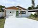 Charming home showcasing a covered entry, fresh exterior paint, and updated landscaping at 5151 7Th N Ave, St Petersburg, FL 33710