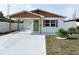 Charming house features a covered entry, a green door, and updated landscaping at 5151 7Th N Ave, St Petersburg, FL 33710