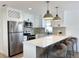 Bright kitchen with stainless steel appliances, breakfast bar, and white cabinets at 5151 7Th N Ave, St Petersburg, FL 33710
