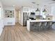 Open concept kitchen featuring stainless steel appliances, a breakfast bar, and a modern design at 5151 7Th N Ave, St Petersburg, FL 33710