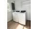 Well-lit laundry room with modern washer and dryer, new flooring and shelving at 5151 7Th N Ave, St Petersburg, FL 33710