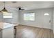 Bright living room with ceiling fan, multiple windows, and new flooring at 5151 7Th N Ave, St Petersburg, FL 33710