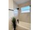 Renovated bathroom features a tub and shower combination with stylish tile and sleek, black fixtures at 5151 7Th N Ave, St Petersburg, FL 33710