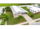 An aerial of a home with a covered patio, neat landscaping, mature trees and driveway at 5451 Antigua Dr, Zephyrhills, FL 33541