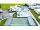 Community aerial view showcasing clubhouse, pool, shuffleboard courts, and well-maintained grounds at 5451 Antigua Dr, Zephyrhills, FL 33541
