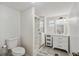 Bright bathroom with a glass enclosed shower, tiled floors, and white vanity at 5451 Antigua Dr, Zephyrhills, FL 33541