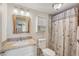 Bright bathroom featuring a granite countertop, a white vanity, and a shower at 5451 Antigua Dr, Zephyrhills, FL 33541