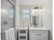 Updated bathroom featuring a glass shower, white vanity, and modern fixtures at 5451 Antigua Dr, Zephyrhills, FL 33541