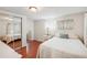 Bright bedroom featuring hardwood floors, large closet, and a comfortable bed at 5451 Antigua Dr, Zephyrhills, FL 33541