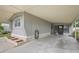 Spacious covered carport area with direct access to the home and featuring tidy brick risers at 5451 Antigua Dr, Zephyrhills, FL 33541
