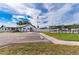 Exterior shot of a well-maintained community clubhouse with parking and recreational areas on a sunny day at 5451 Antigua Dr, Zephyrhills, FL 33541