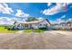 Charming single-story community clubhouse with golf carts, bicycles, and bulletin board at 5451 Antigua Dr, Zephyrhills, FL 33541