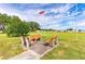 Scenic common area with park benches and an American flag, providing a serene space for relaxation and reflection at 5451 Antigua Dr, Zephyrhills, FL 33541