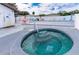 Community hot tub area with colorful lounge chairs and a pristine pool, perfect for relaxing and socializing at 5451 Antigua Dr, Zephyrhills, FL 33541