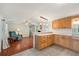 Open kitchen with light wood cabinets, extended counter space and easy access to the living area at 5451 Antigua Dr, Zephyrhills, FL 33541