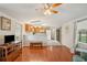 Living room featuring hardwood floors, ceiling fan, and open access to the kitchen at 5451 Antigua Dr, Zephyrhills, FL 33541