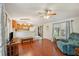 Open-concept living room featuring hardwood floors, ceiling fan, and view of the kitchen at 5451 Antigua Dr, Zephyrhills, FL 33541