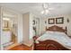 Bedroom showcases a decorative bed frame, a closet, and a peek into the en-suite bathroom at 5451 Antigua Dr, Zephyrhills, FL 33541
