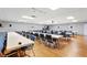 Spacious meeting room featuring rows of tables and chairs with hardwood floors and ample lighting at 5451 Antigua Dr, Zephyrhills, FL 33541