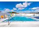 Beautiful in-ground pool and jacuzzi with lounge seating, and a white fence surround at 5451 Antigua Dr, Zephyrhills, FL 33541