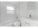 Clean bathroom featuring white subway tile, shower, and sleek white vanity at 546 90Th N Ave, St Petersburg, FL 33702