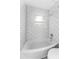 Bright bathroom featuring white subway tile, shower, and a window at 546 90Th N Ave, St Petersburg, FL 33702