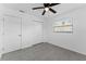 Empty bedroom features a ceiling fan, bright window, and modern tile flooring at 546 90Th N Ave, St Petersburg, FL 33702