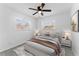 Sunlit bedroom features a ceiling fan, bright windows, and comfortable furniture at 546 90Th N Ave, St Petersburg, FL 33702