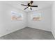 Sunlit bedroom features a ceiling fan, bright windows, and modern tile flooring at 546 90Th N Ave, St Petersburg, FL 33702