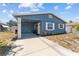 Charming blue home with a well-manicured yard and covered entrance at 546 90Th N Ave, St Petersburg, FL 33702