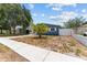 Charming blue single story home with small palm tree in front yard at 546 90Th N Ave, St Petersburg, FL 33702