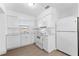 Well-lit kitchen features matching white appliances, countertops, and tile flooring at 546 90Th N Ave, St Petersburg, FL 33702