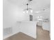 Bright kitchen featuring modern lighting fixture, breakfast bar, and tile flooring at 546 90Th N Ave, St Petersburg, FL 33702