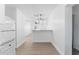 Bright kitchen view featuring modern lighting fixture, breakfast bar, and tile flooring at 546 90Th N Ave, St Petersburg, FL 33702