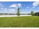 Lush backyard with green lawn and serene lake view, perfect for outdoor enjoyment at 6129 Marsh Trail Dr, Odessa, FL 33556