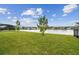 Beautiful backyard with lush green grass and tranquil lake views at 6129 Marsh Trail Dr, Odessa, FL 33556