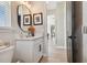 Elegant powder room featuring a decorative mirror, modern fixtures, and wood-look tile at 6129 Marsh Trail Dr, Odessa, FL 33556