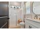 Bathroom featuring a glass-enclosed shower, tiled floors, and modern vanity with gold fixtures at 6129 Marsh Trail Dr, Odessa, FL 33556