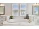 Beautiful bathroom featuring a soaking tub, marble countertops, and double sink vanities at 6129 Marsh Trail Dr, Odessa, FL 33556