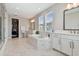 The bathroom features a soaking tub, marble countertops, and double sink vanities at 6129 Marsh Trail Dr, Odessa, FL 33556
