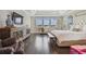 Bright bedroom with hardwood floors, a decorative cabinet, and a large bed under a trey ceiling at 6129 Marsh Trail Dr, Odessa, FL 33556
