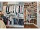Walk-in closet with custom shelving providing ample storage for clothing, shoes, and accessories at 6129 Marsh Trail Dr, Odessa, FL 33556